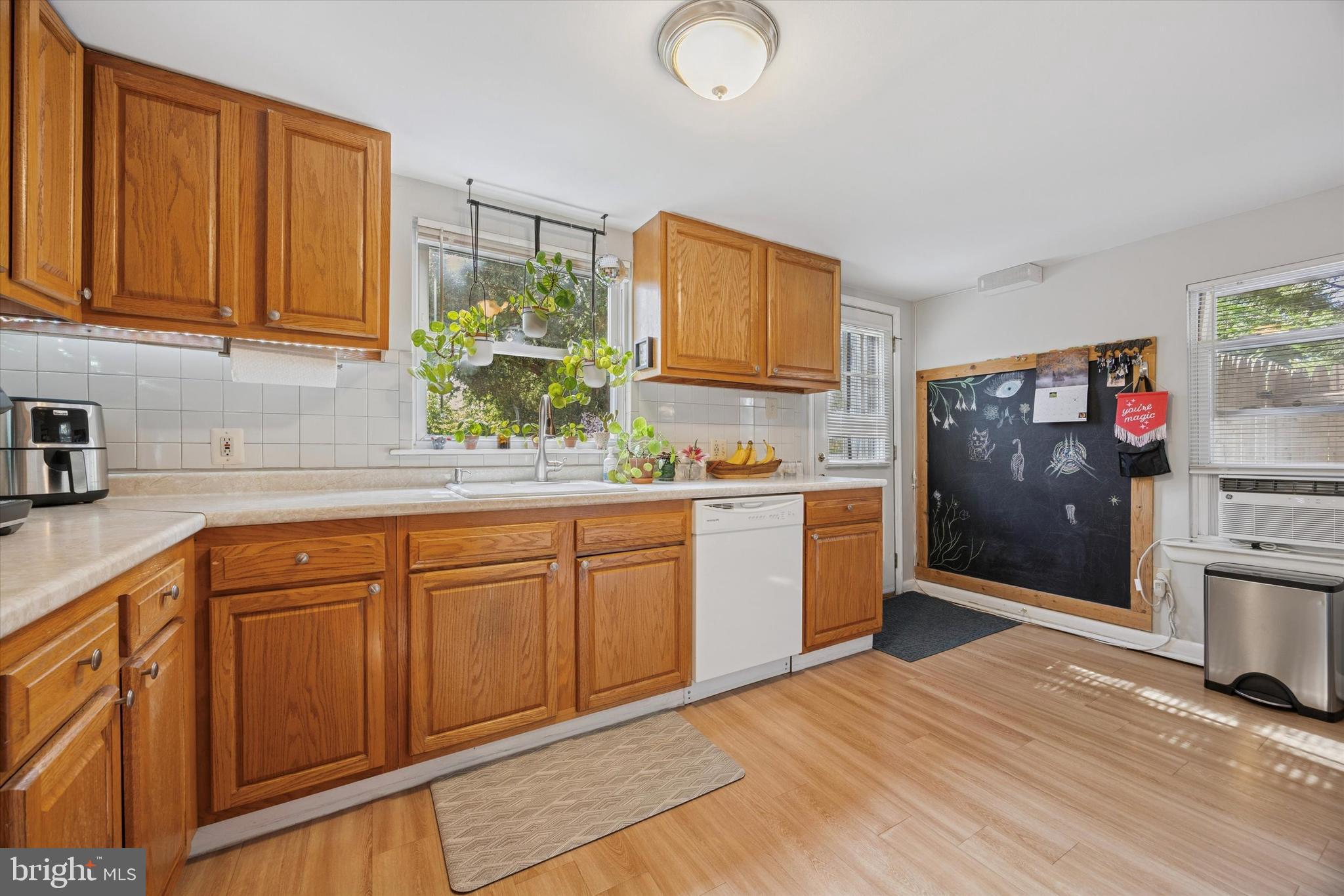 213 Greenfield Avenue Ardmore, PA 19003 - Photo 6 of 15 a kitchen with stainless steel appliances granite countertop a sink dishwasher stove and cabinets with wooden floor