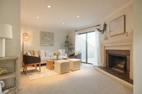 a living room with furniture a window and a fireplace