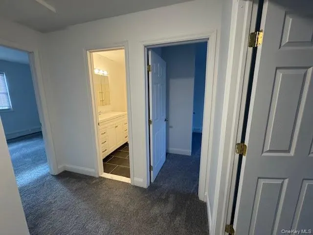 an empty room with a bathroom and a sink