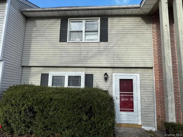 a front view of a house with plants