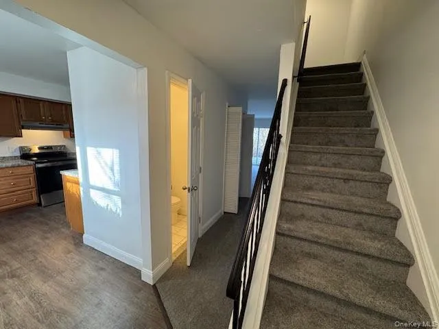 a view of a kitchen with wooden floor and electronic appliances