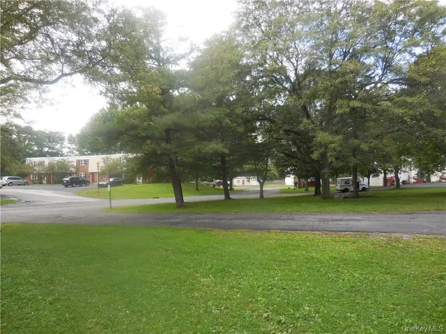 a view of playground with slide and bench