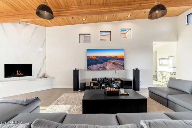 a bedroom with a bed and large window with balcony view