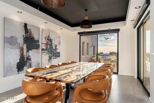 a view of a dining room with furniture wooden floor and a potted plant