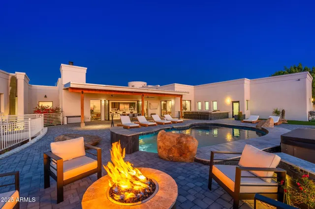 a view of a house with swimming pool and sitting area