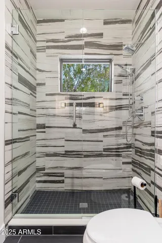 a view of a terrace with furniture and a floor to ceiling window