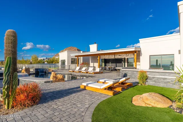 a kitchen with stainless steel appliances granite countertop a sink and a refrigerator