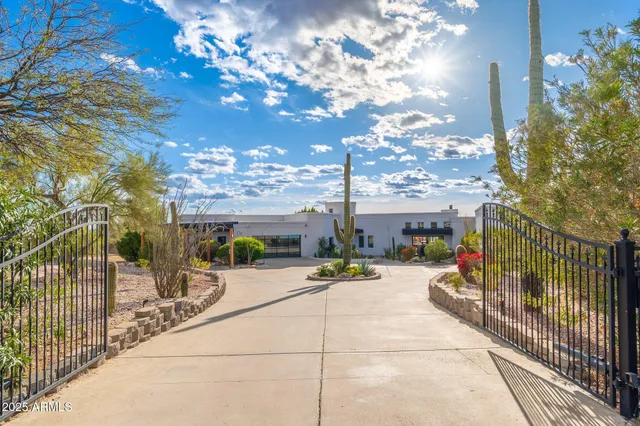 a kitchen with lots of counter and chairs
