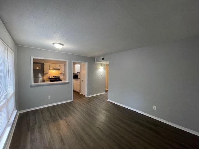 605 Patterson Street, Unit 9 Memphis, TN 38111 - Photo 2 of 10 an empty room with wooden floor and windows