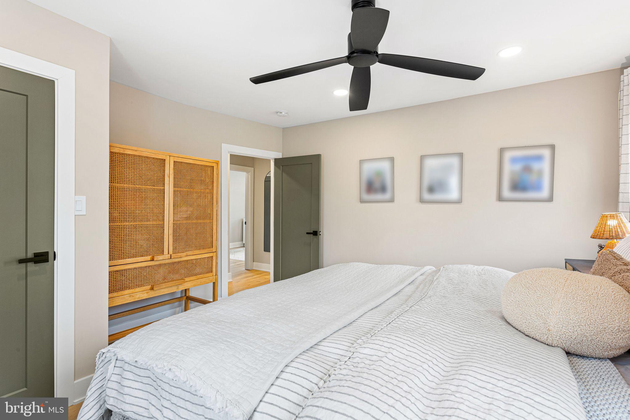1 Maple Avenue Haddon Township, NJ 08108 - Photo 27 of 87 a bedroom with a large bed and a chandelier