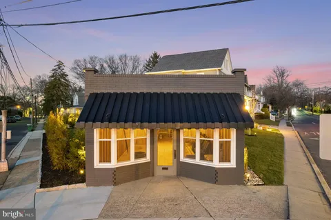 an aerial view of a house with yard porch and furniture