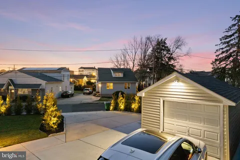 a view of a house with a small yard and wooden fence