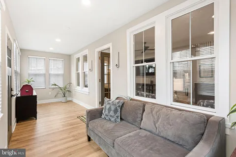 a bedroom with furniture and wooden floor