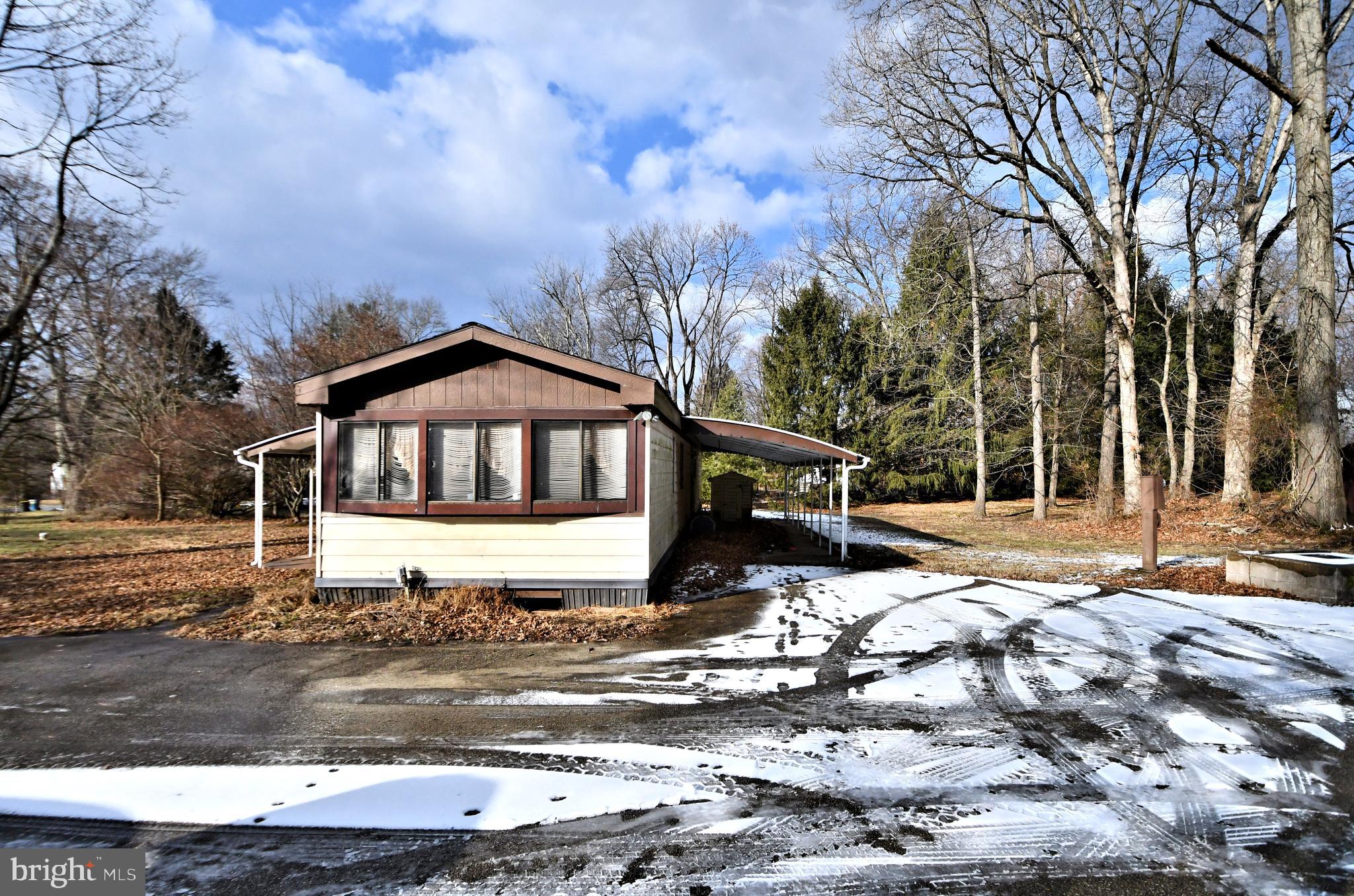 433 Saylors Mill Road Spring City, PA 19475 - Photo 1 of 40 a front view of a house with a yard covered with snow