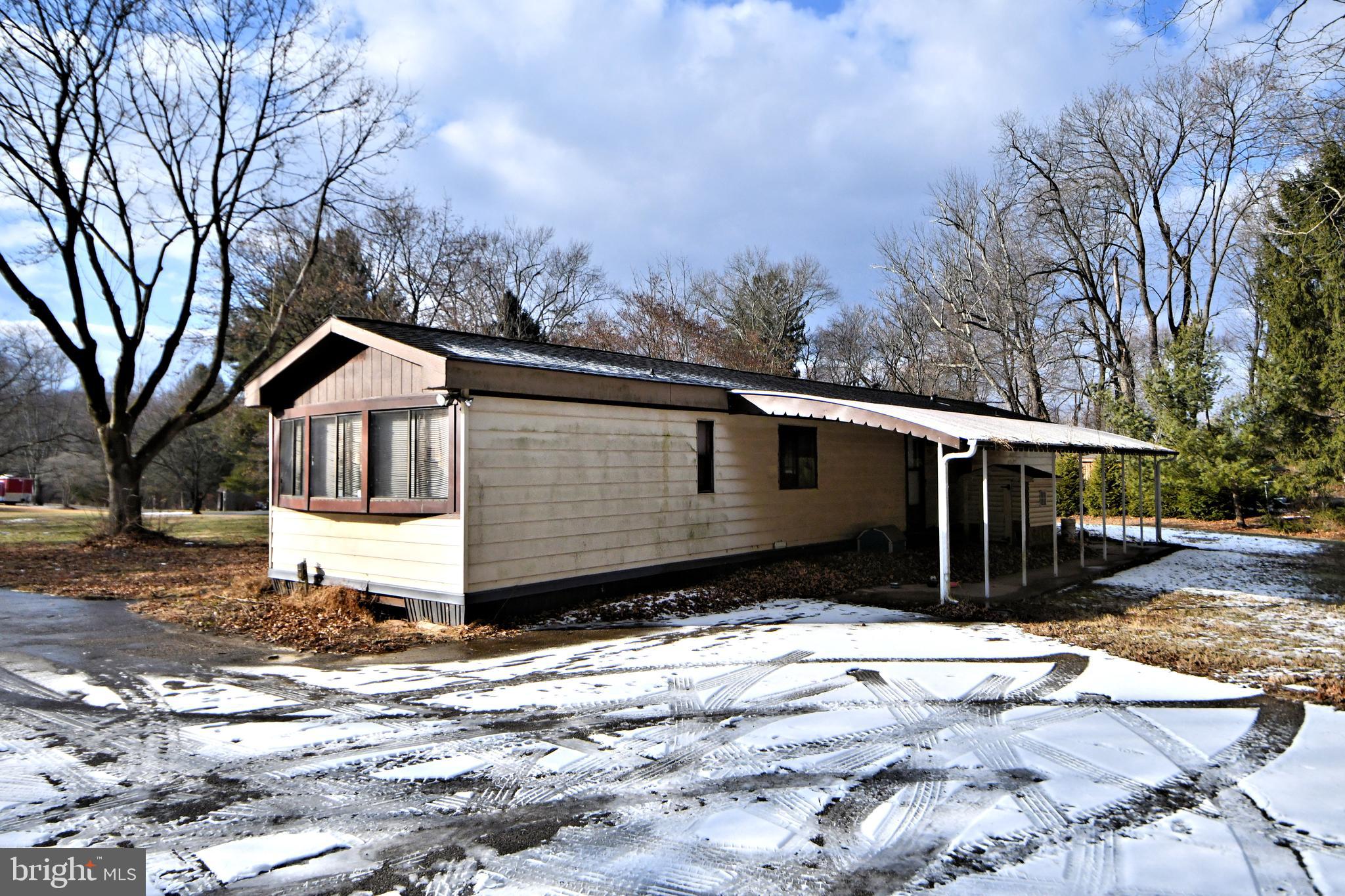 433 Saylors Mill Road Spring City, PA 19475 - Photo 3 of 40 a front view of a house with a yard covered in snow