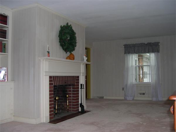 5 Millbrook Road Beverly, MA 01915 - Photo 3 of 5 a living room with a fireplace and potted plant