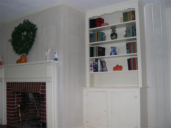 5 Millbrook Road Beverly, MA 01915 - Photo 4 of 5 a shelf with books and knick knacks on it
