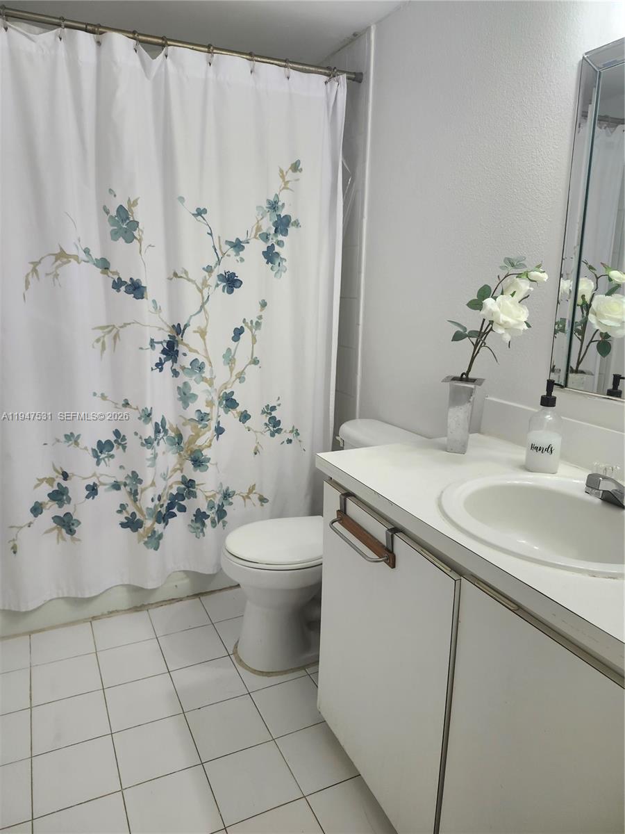 17901 Northwest 68th Avenue, Unit T103 Hialeah, FL 33015 - Photo 2 of 24 a bathroom with a sink toilet and shower