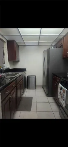 a view of kitchen with refrigerator