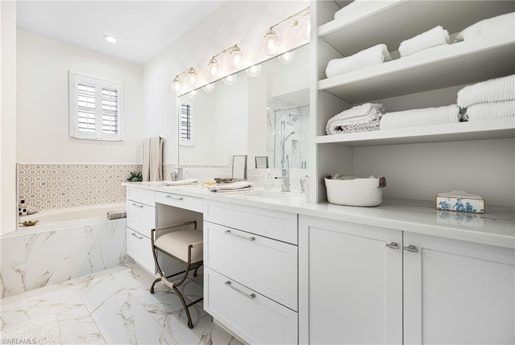 19071 Ridgepoint Drive, Unit 202 Estero, FL 33928 - Photo 17 of 26 Bathroom with vanity and separate shower and tub