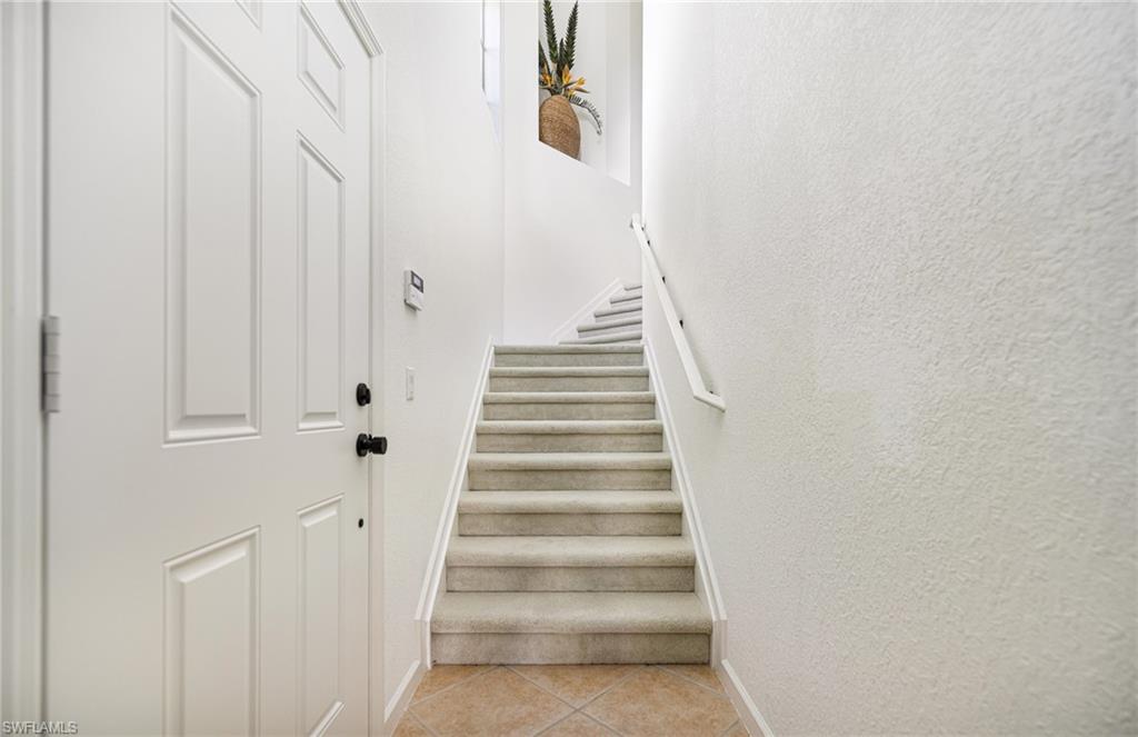 19071 Ridgepoint Drive, Unit 202 Estero, FL 33928 - Photo 2 of 26 Stairway with tile patterned floors
