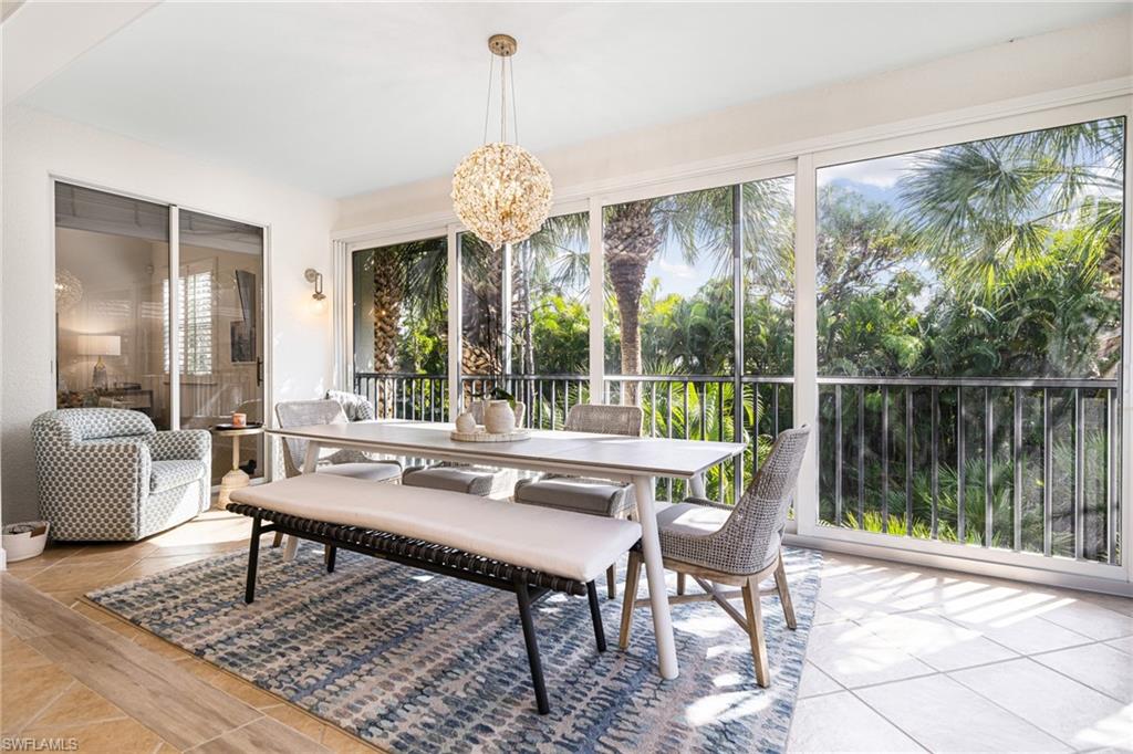19071 Ridgepoint Drive, Unit 202 Estero, FL 33928 - Photo 7 of 26 Sunroom / solarium featuring an inviting chandelier