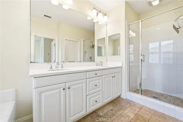 a bathroom with double sink and a mirror
