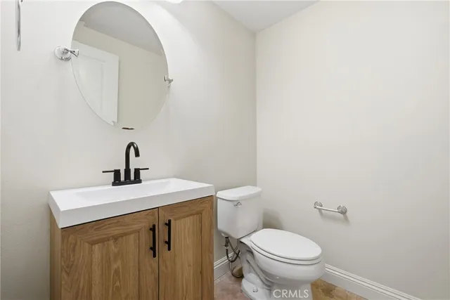 a bathroom with a sink a toilet and mirror