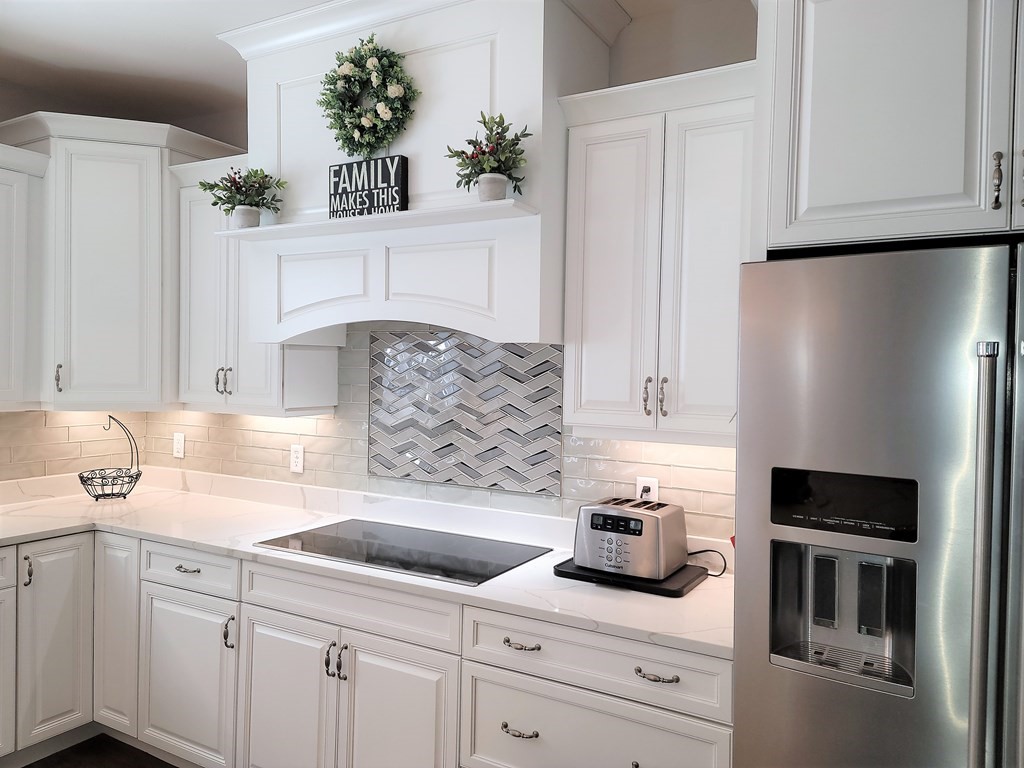 70 Ryan Farm Road, Unit 13 Windham, NH 03087 - Photo 6 of 13 a kitchen with white cabinets and white appliances