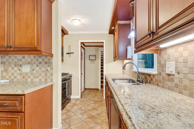 a bathroom with a granite countertop sink a mirror and shower