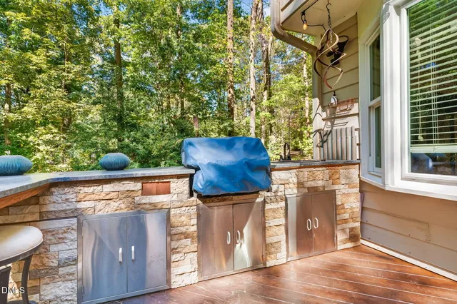 a lawn chairs sitting under a blue umbrella