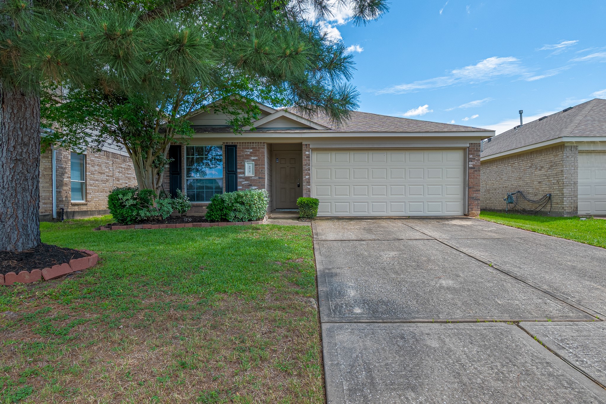 a front view of a house with a garden and yard