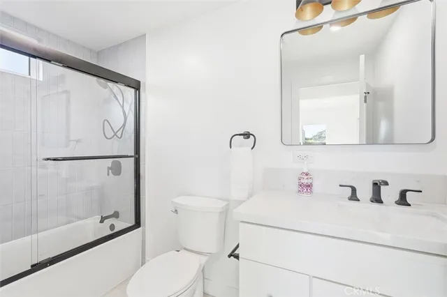 a bathroom with a toilet sink and a shower