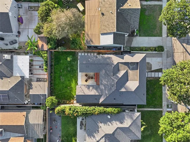 an aerial view of residential houses with outdoor space and parking