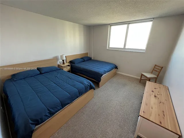 a bedroom with two beds and a window