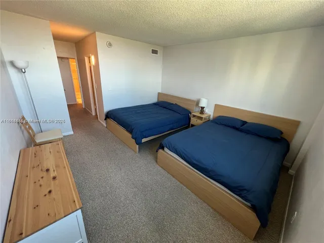 a bedroom with bed and mirror