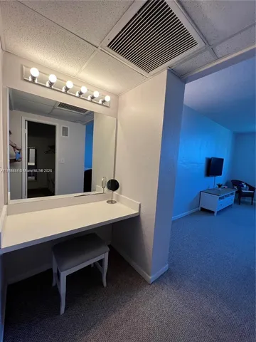 a view of a livingroom with furniture and a large window