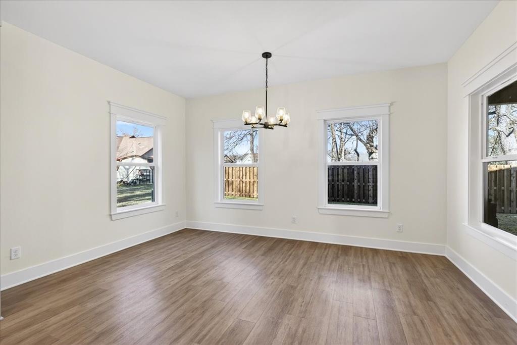 114 Castlewood Road Enchanted Oaks, TX 75156 - Photo 14 of 33 a view of an empty room with wooden floor and a window