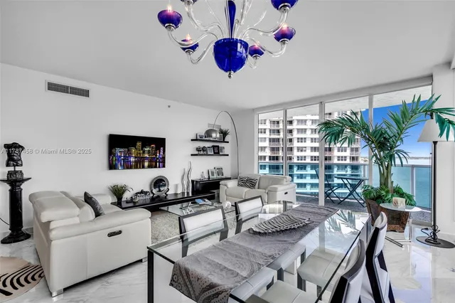 a living room with furniture potted plant and a large window