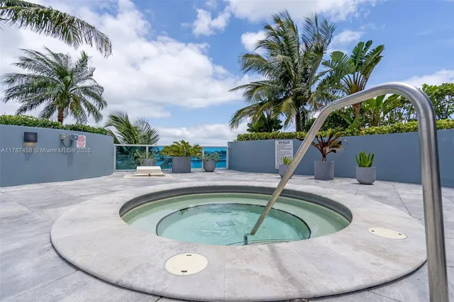 a view of swimming pool with outdoor seating and plants