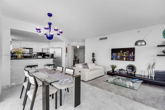a living room with furniture and kitchen view