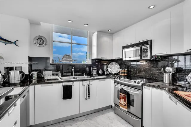 a kitchen with a stove sink and cabinets
