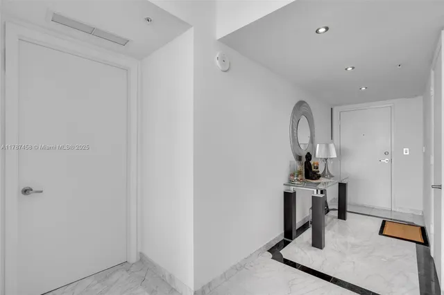 a view of a dining room with furniture and a floor to ceiling window