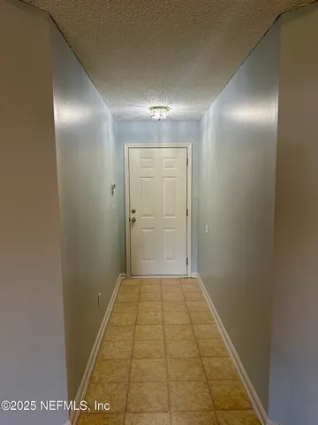a view of a kitchen with a sink and a window