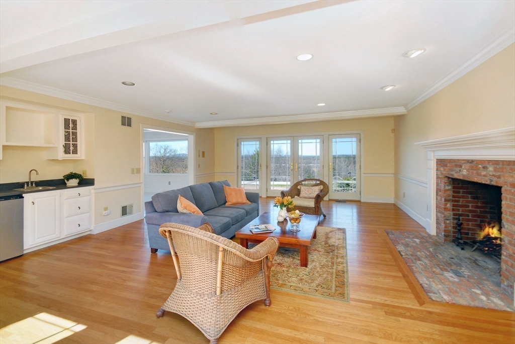 21 Kettle Hole Road Bolton, MA 01740 - Photo 11 of 39 a living room with fireplace furniture and a wooden floor