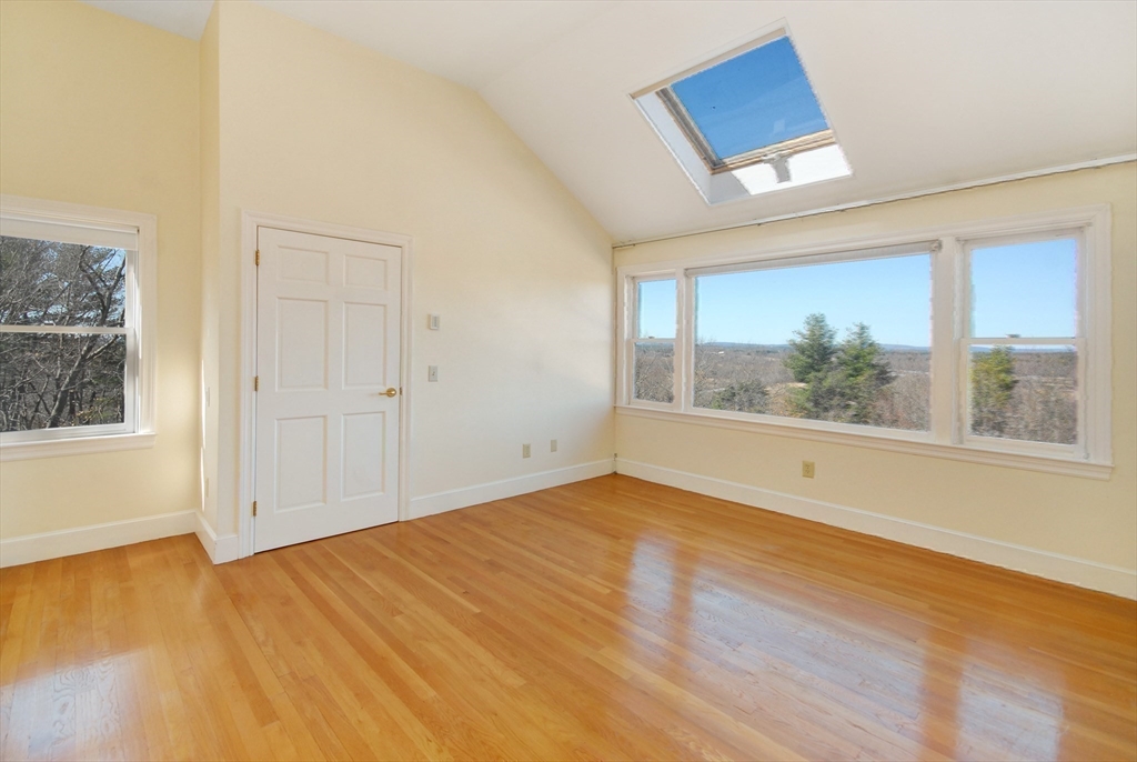21 Kettle Hole Road Bolton, MA 01740 - Photo 22 of 39 an empty room with wooden floor and windows