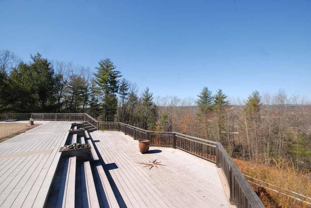 21 Kettle Hole Road Bolton, MA 01740 - Photo 33 of 39 a view of a balcony with wooden floor and trees