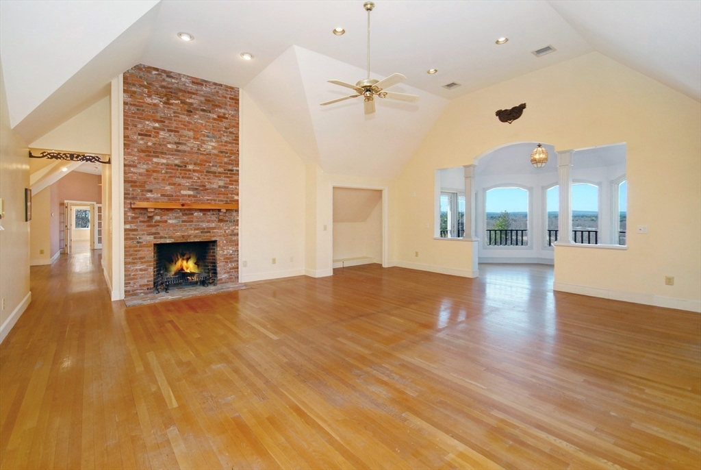 21 Kettle Hole Road Bolton, MA 01740 - Photo 6 of 39 a view of an empty room with wooden floor and a fireplace