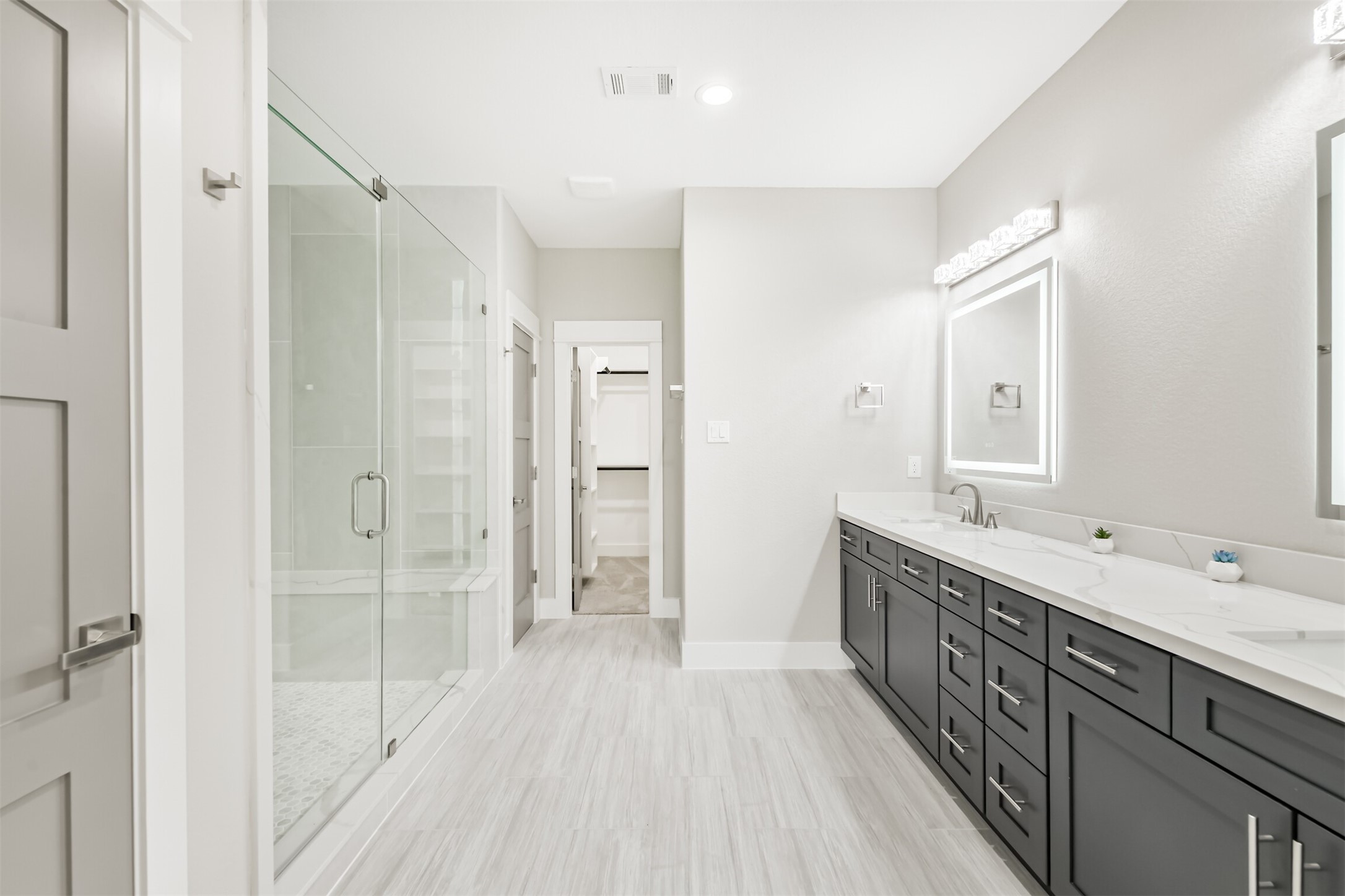 2643 Dalview Street Houston, TX 77091 - Photo 4 of 12 a bathroom with a double vanity sink a mirror and a shower