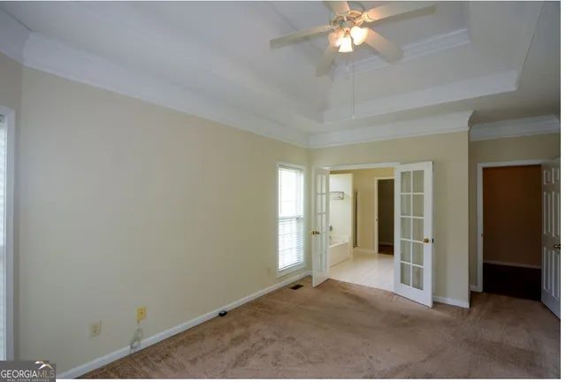 an empty room with closet and a chandelier fan
